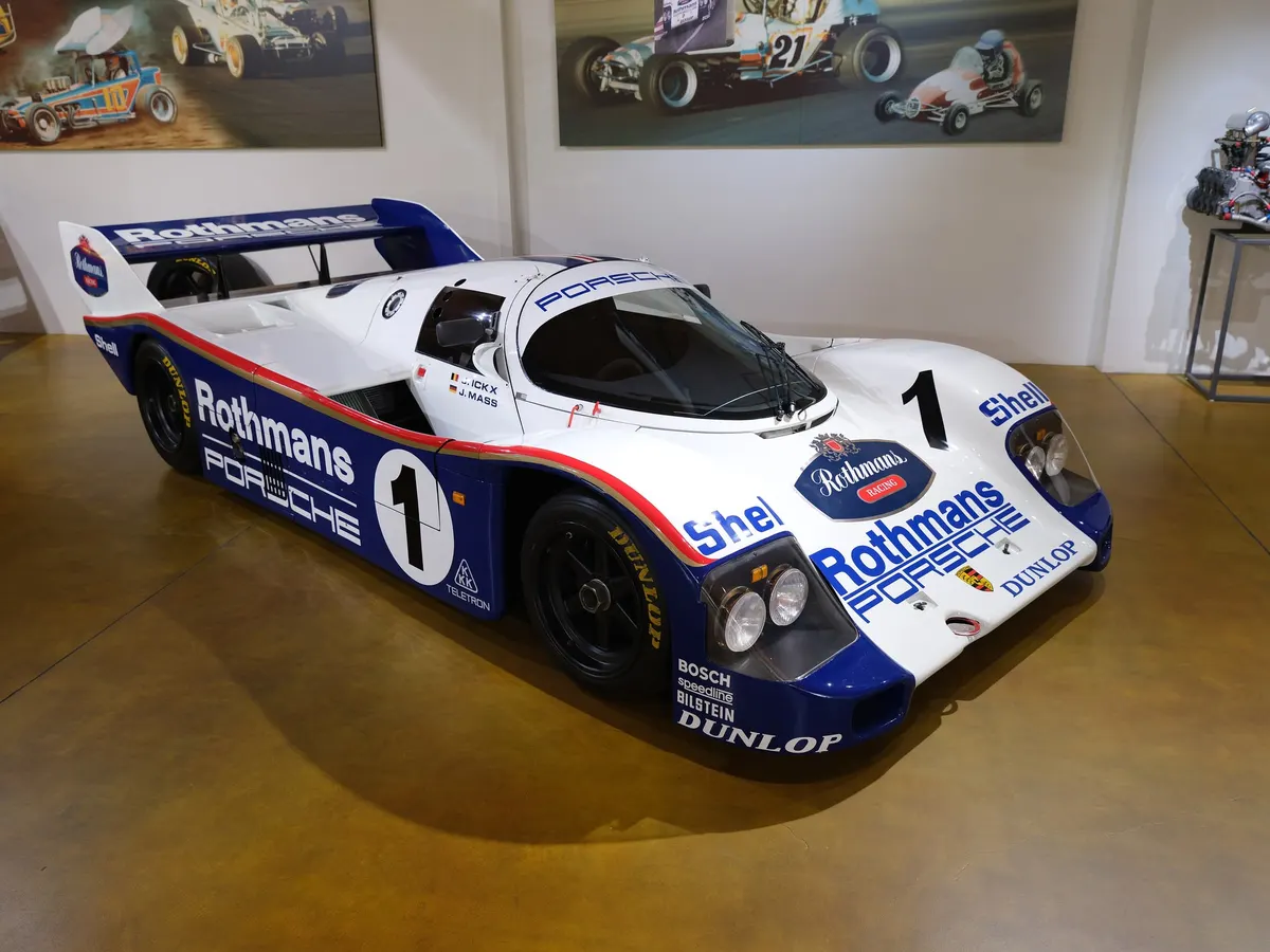 Model illustration: a Porsche 962C in white and blue Rothmans livery, number 1, photographed in California. This is not the car on display in the Spa-Francorchamps museum